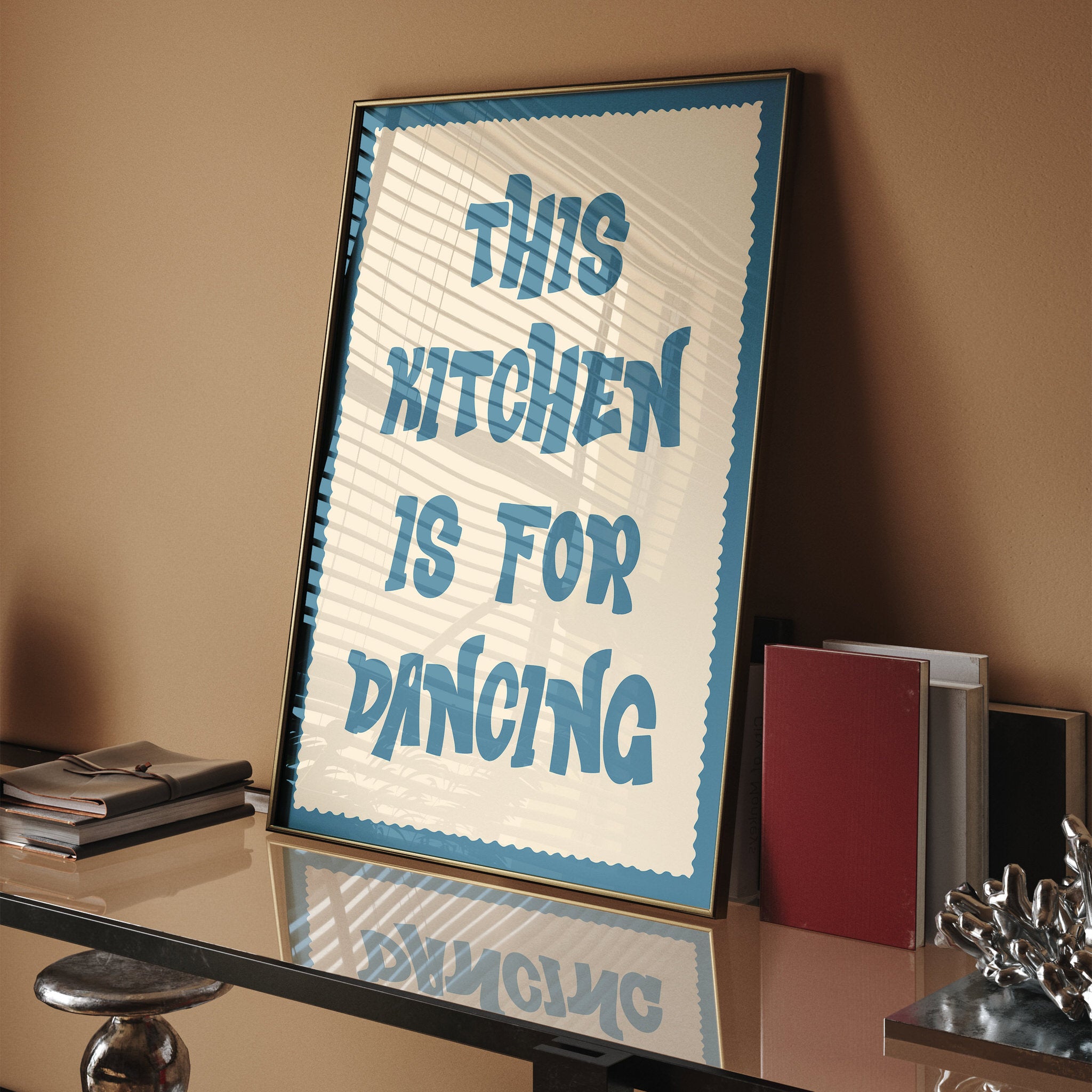 Whimsical wall art with teal text "This Kitchen Is For Dancing" in retro style
